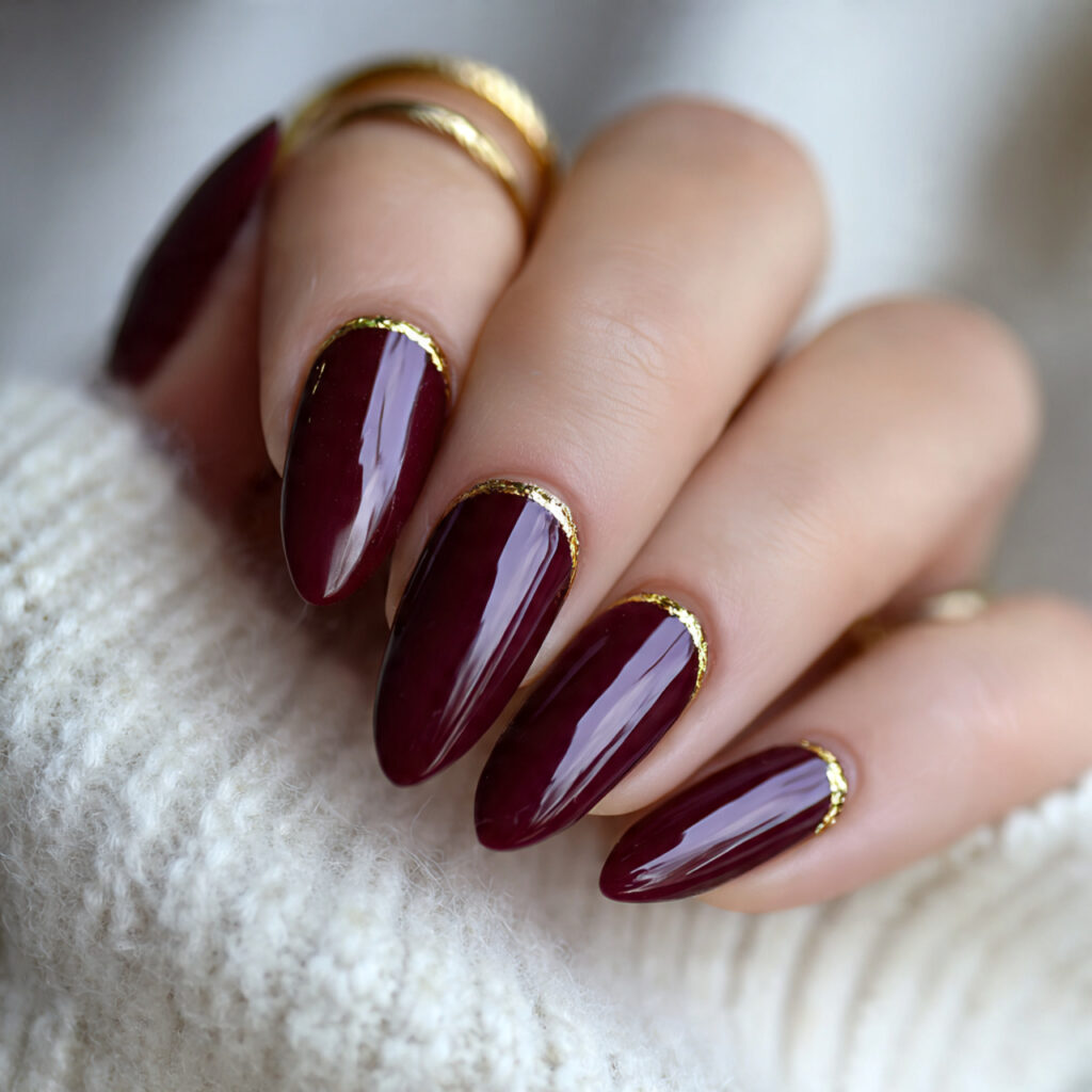 deep burgundy with gold cuticle line nails