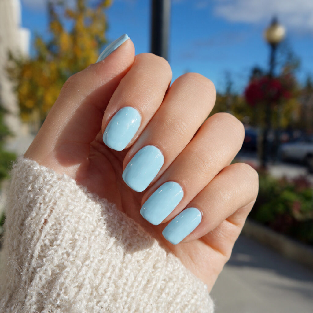 attractive baby blue glazed nails with outdoor bac