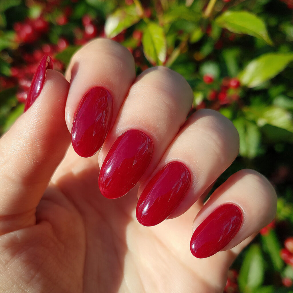 attractive cherry red jelly nails with outdoor bac