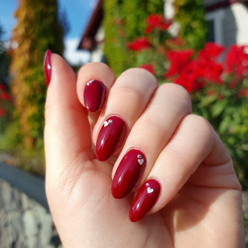 attractive cherry red with tiny heart accent nails