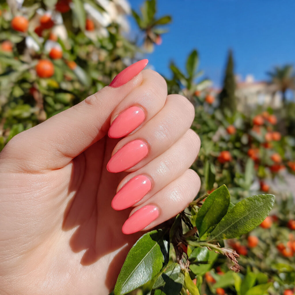 attractive coral pink and mango nails with outdoor