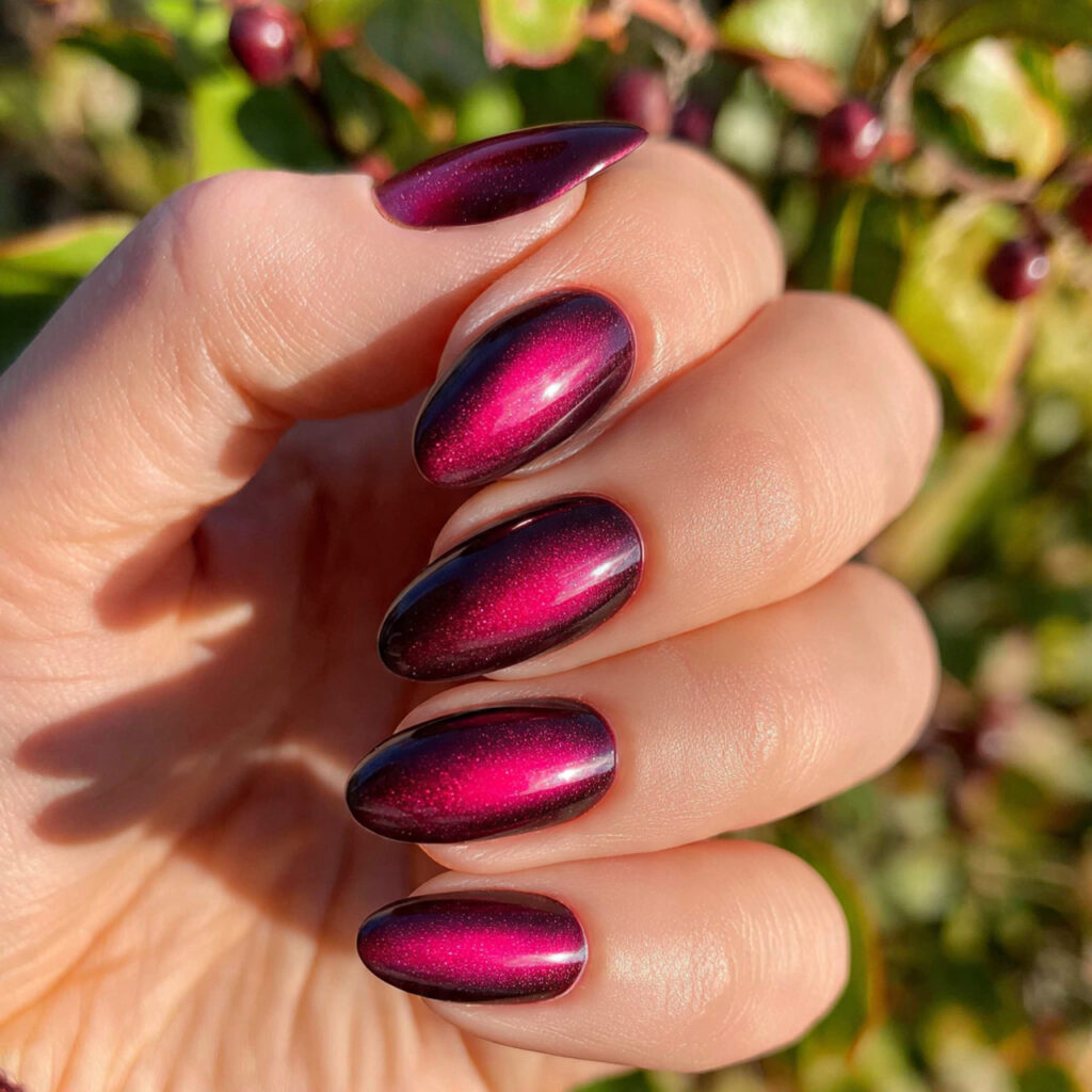 attractive dark pink cat eye nails with outdoor ba