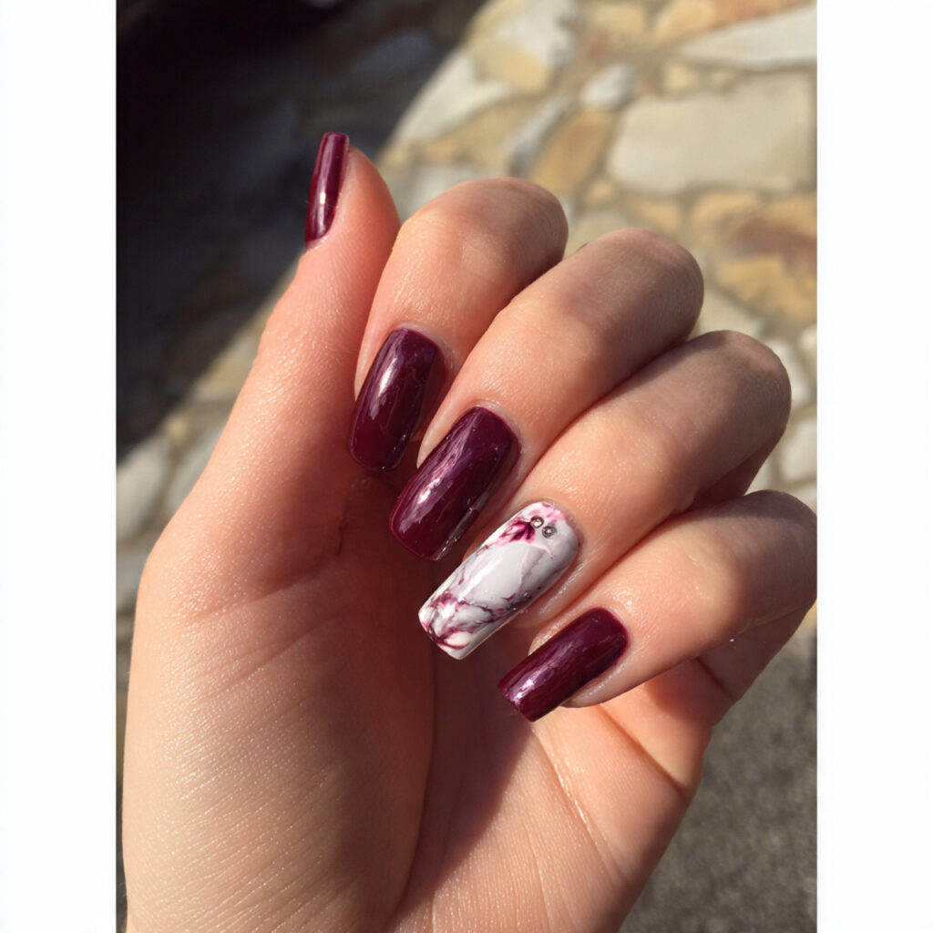 attractive deep garnet prom nails with marble acce 1