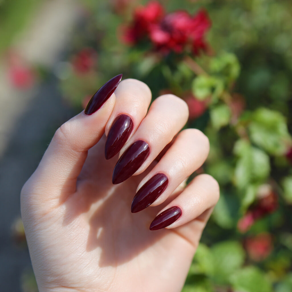 attractive deep garnet stiletto acrylic nails with