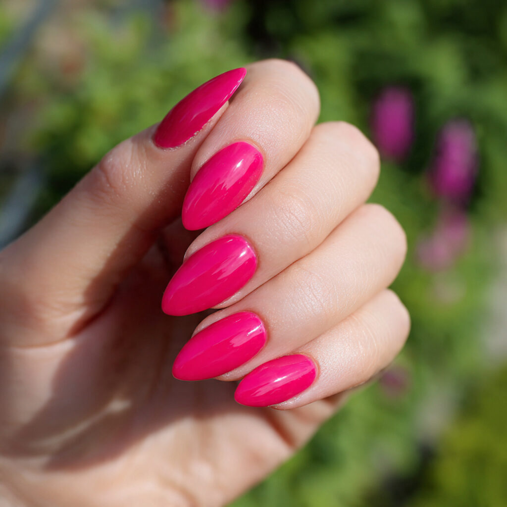 attractive hot pink almond nails with outdoor summ
