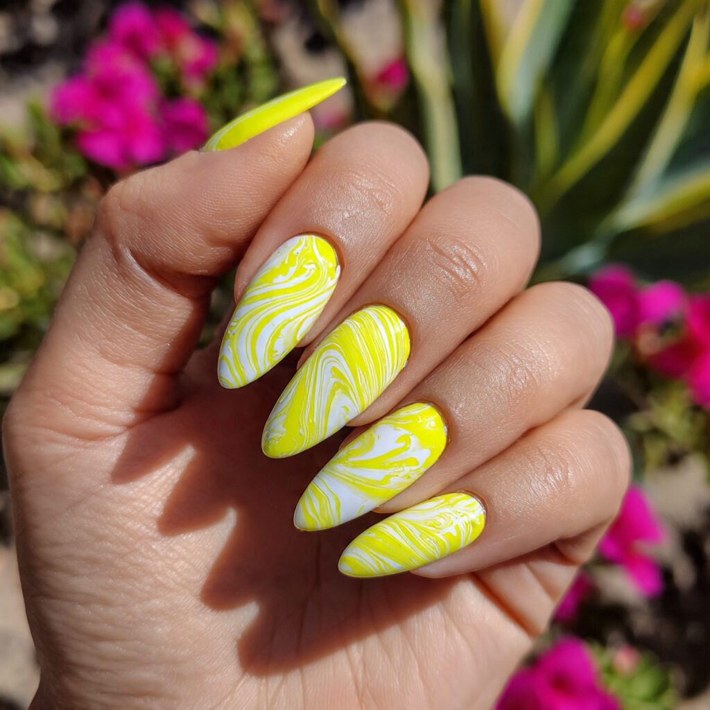 attractive neon lemon pop with white swirls nails
