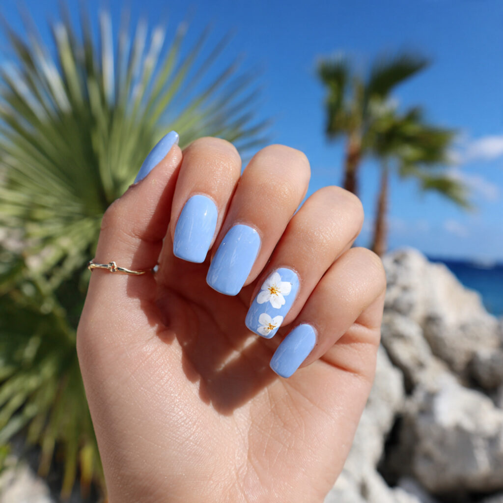 attractive pastel blue nails with white flower acc