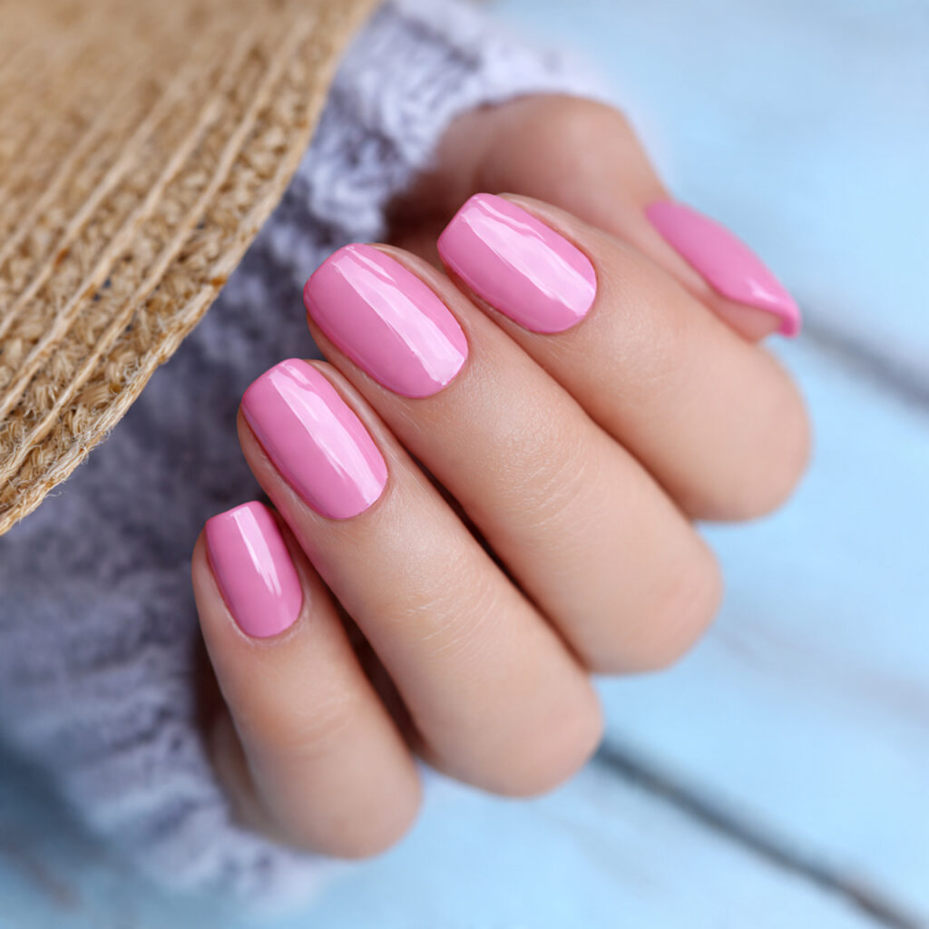 attractive pink glazed nails outdoor summer backgr
