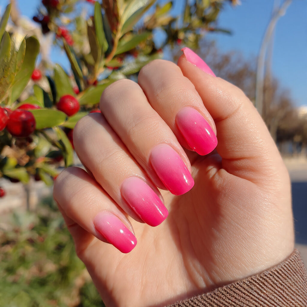 attractive pink ombre nails with outdoor backgroun