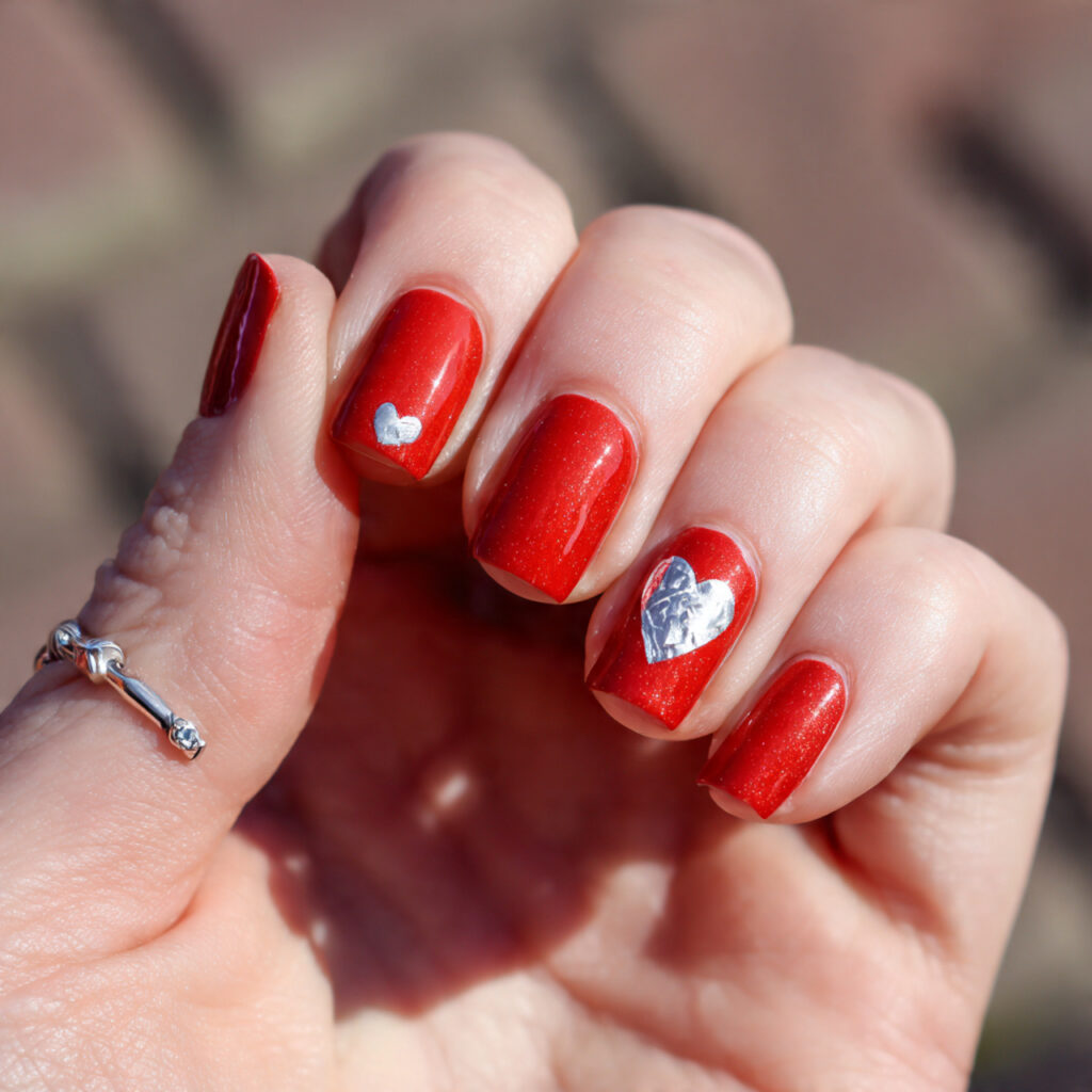 attractive red base with silver heart accent nails