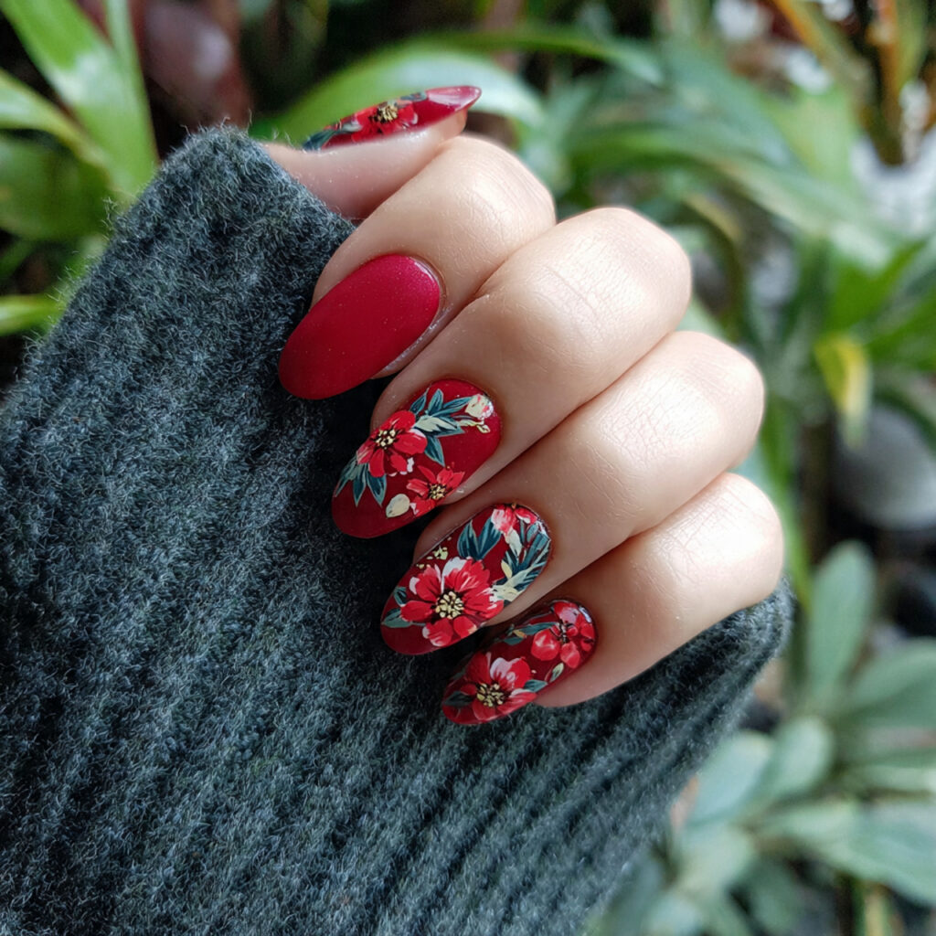 attractive red flower tips on short oval nails wit