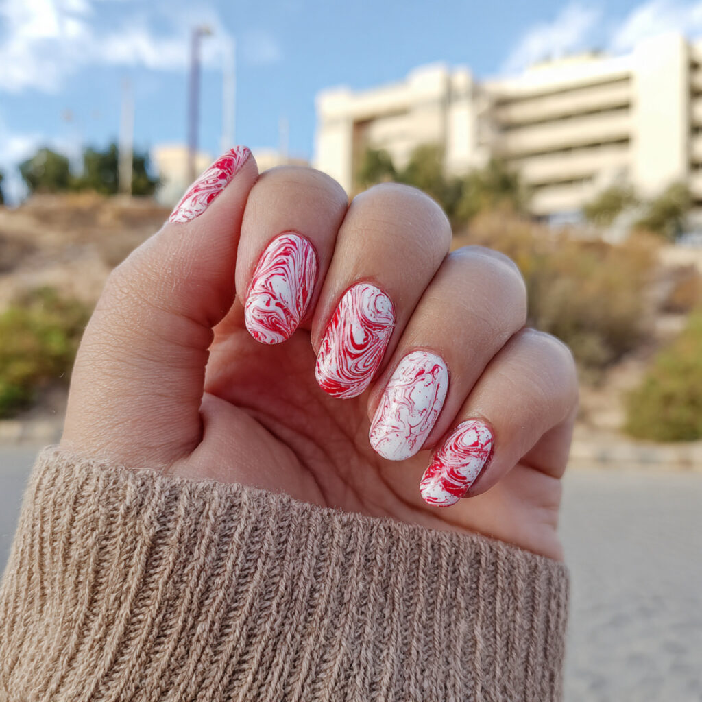 attractive red swirls over white base nails with o