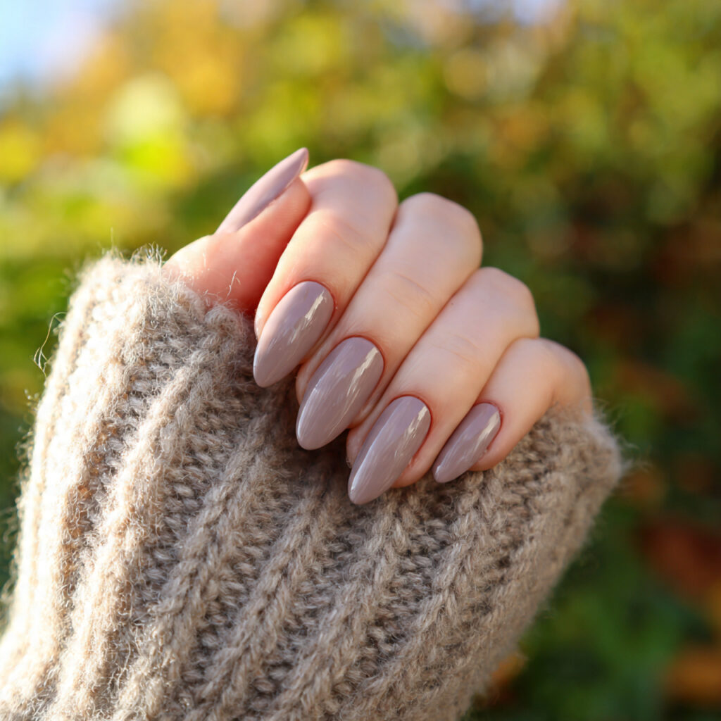 attractive soft taupe almond nails with outdoor ba