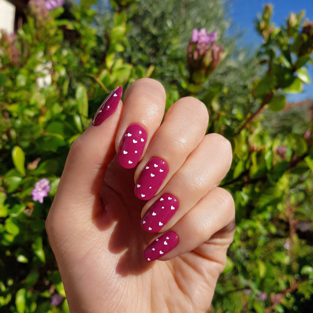 attractive tiny heart dark pink nails with outdoor
