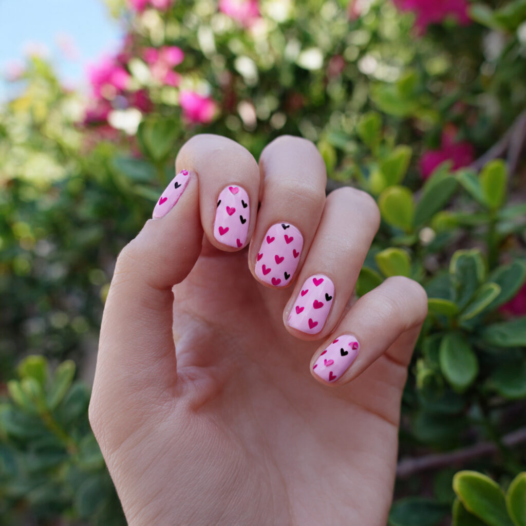 attractive tiny heart pink nails with outdoor back 1