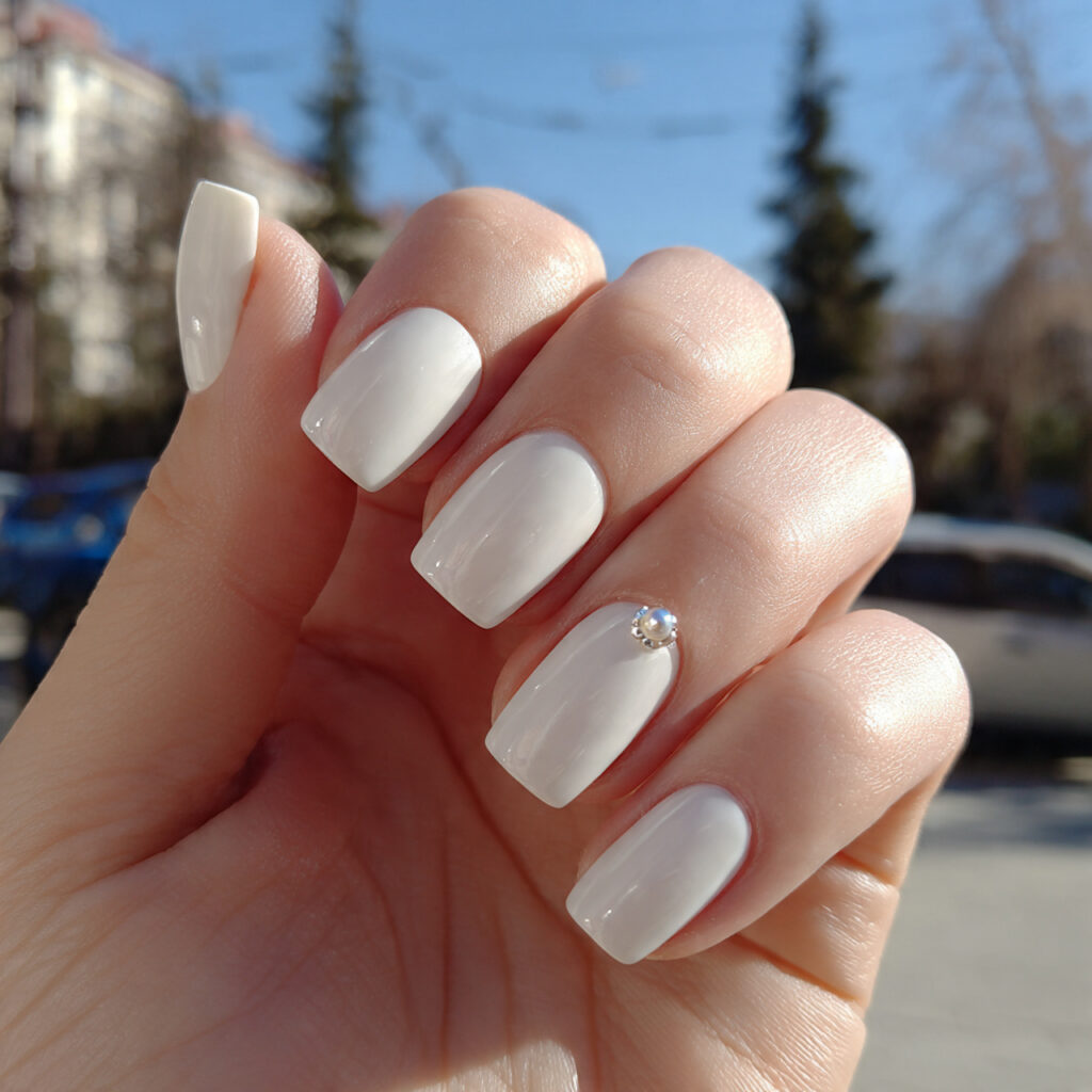 attractive white nails with one pearl accent with 1 1