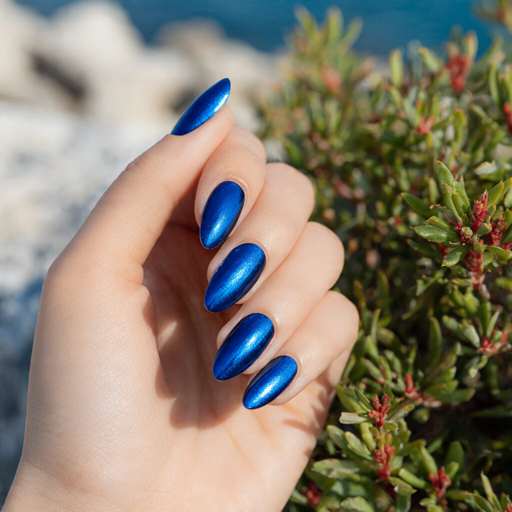 Summer Nails 2026 Blue: Cool, Glossy & Ocean-Inspired Perfection 5 close up of one attractive hand with blue chrome g