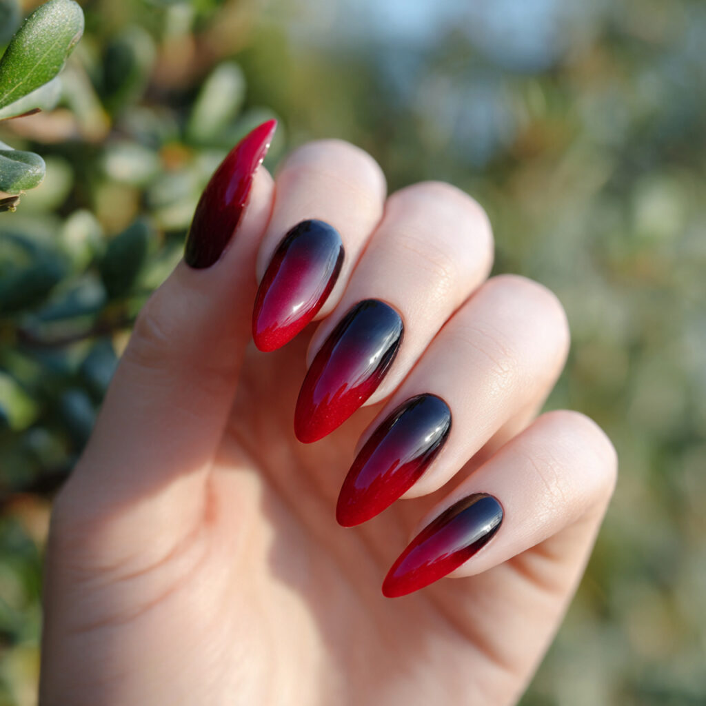 one hand with attractive black to red ombre stilet