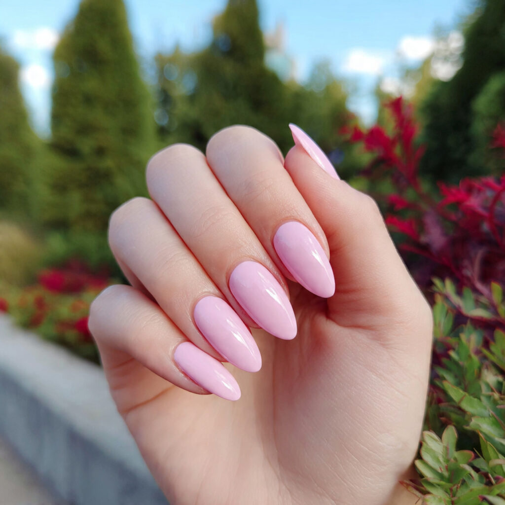 attractive baby pink almond nails with outdoor bac