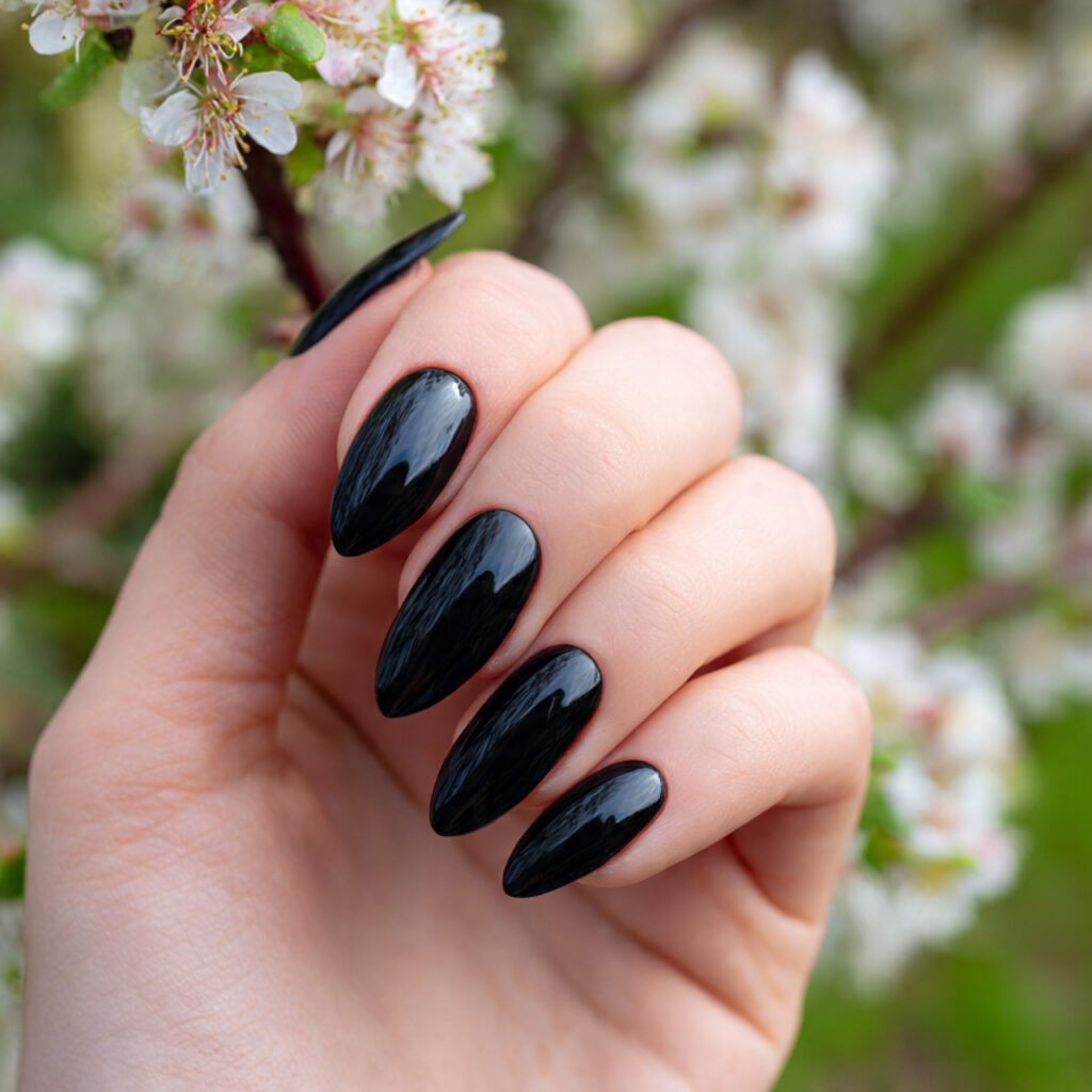 attractive black gloss almond nails with outdoor b