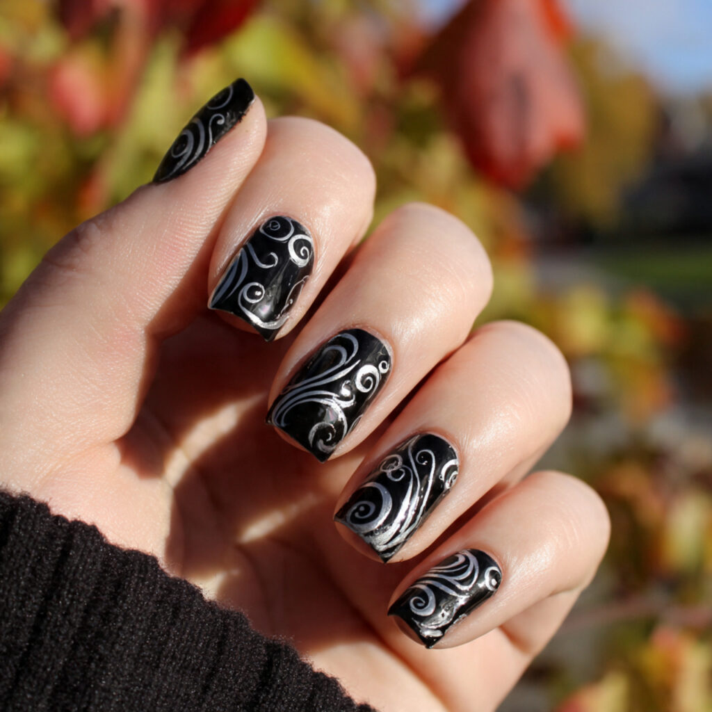 attractive black swirl nail art with outdoor backg