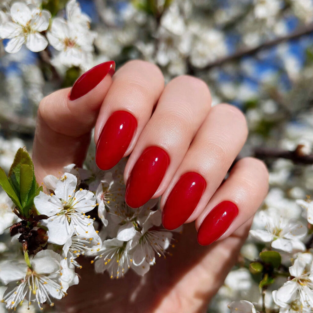 attractive classic red almond nails with outdoor b