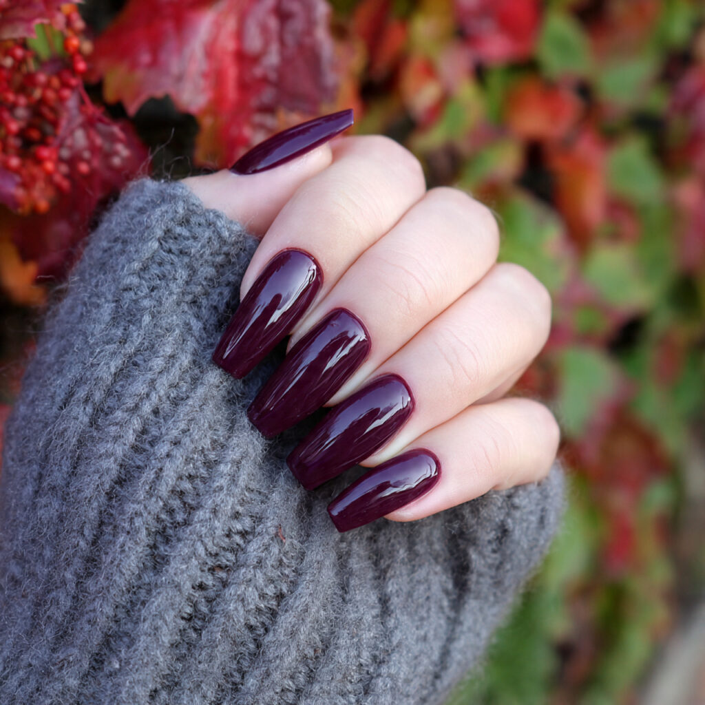 Nail Inspo Purple: 14 Dreamy & Trendy Designs You’ll Love 4 attractive deep plum coffin nails with outdoor bac