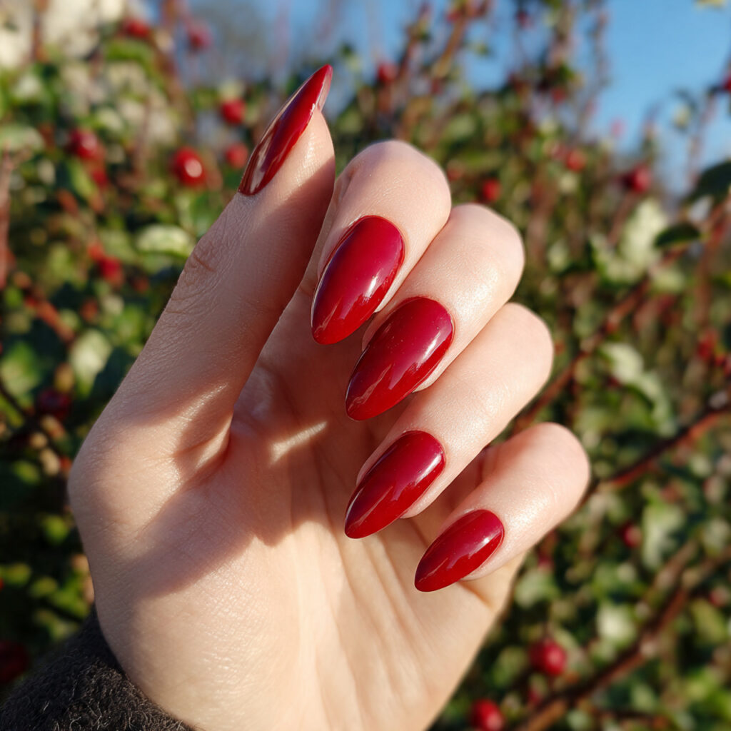 attractive glossy red almond nails with outdoor ba 1