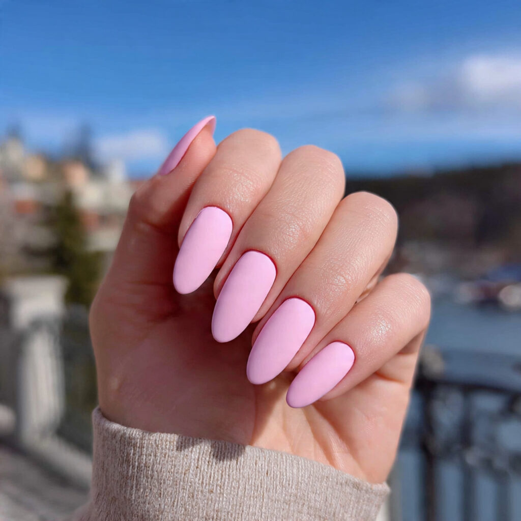 attractive matte pastel pink nails with outdoor ba