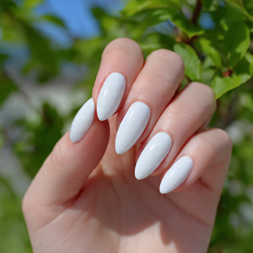 attractive milky white almond nails with outdoor b