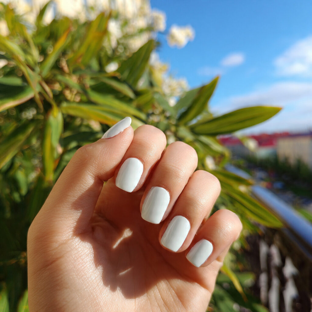 attractive milky white squoval nails with outdoor