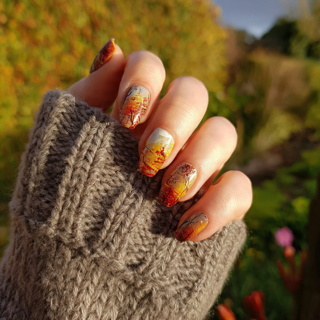 Short Nails Autumn: Cozy, Chic Looks You’ll Fall in Love With 2 attractive warm autumn nails with outdoor backgrou