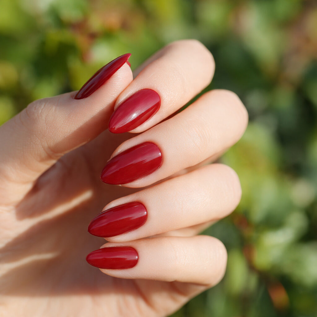 Red Nails Design Ideas Classy Almond: 14 Elegant Looks You’ll Love 14 close up of one hand with almond shaped nails in a