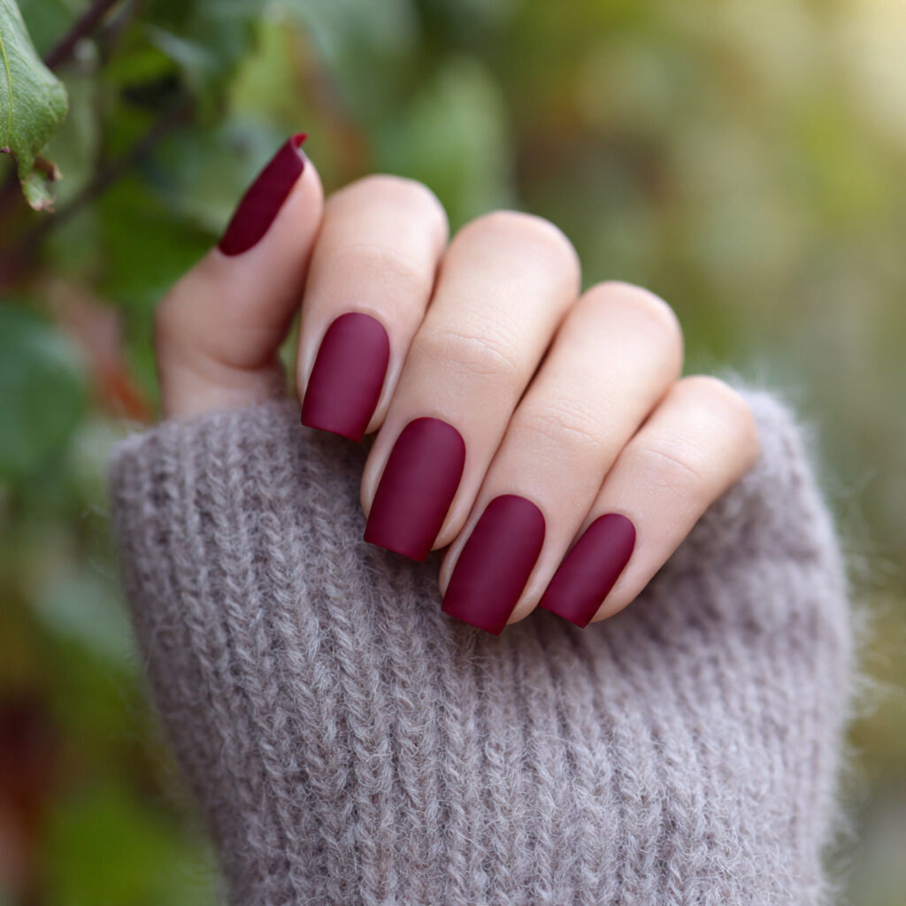 close up of one hand with attractive wine red matt
