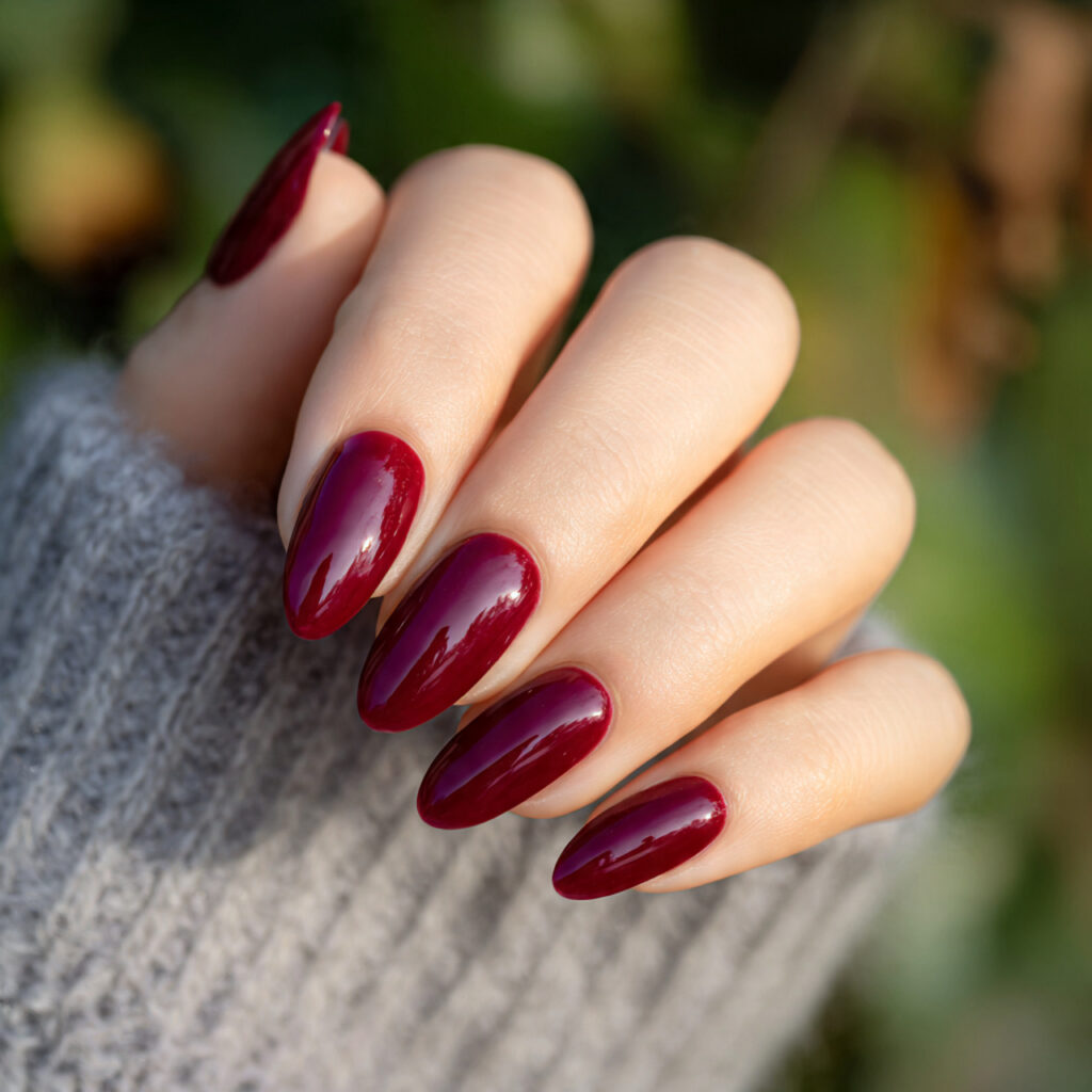 Acrylic Nails Red: The Bold, Timeless Look You’ll Never Get Over 2 close up of one hand with deep wine red almond sha 2