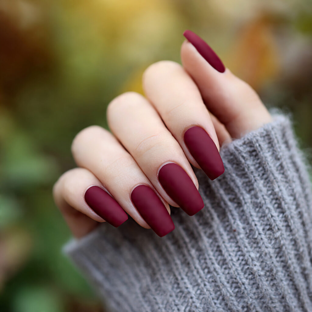 Red Matte Nails: Bold, Velvety Looks That Feel Effortlessly Luxe 8 close up of one hand with matte burgundy coffin na