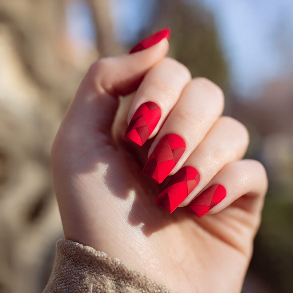 Red Matte Nails: Bold, Velvety Looks That Feel Effortlessly Luxe 11 close up of one hand with matte red geometric nail