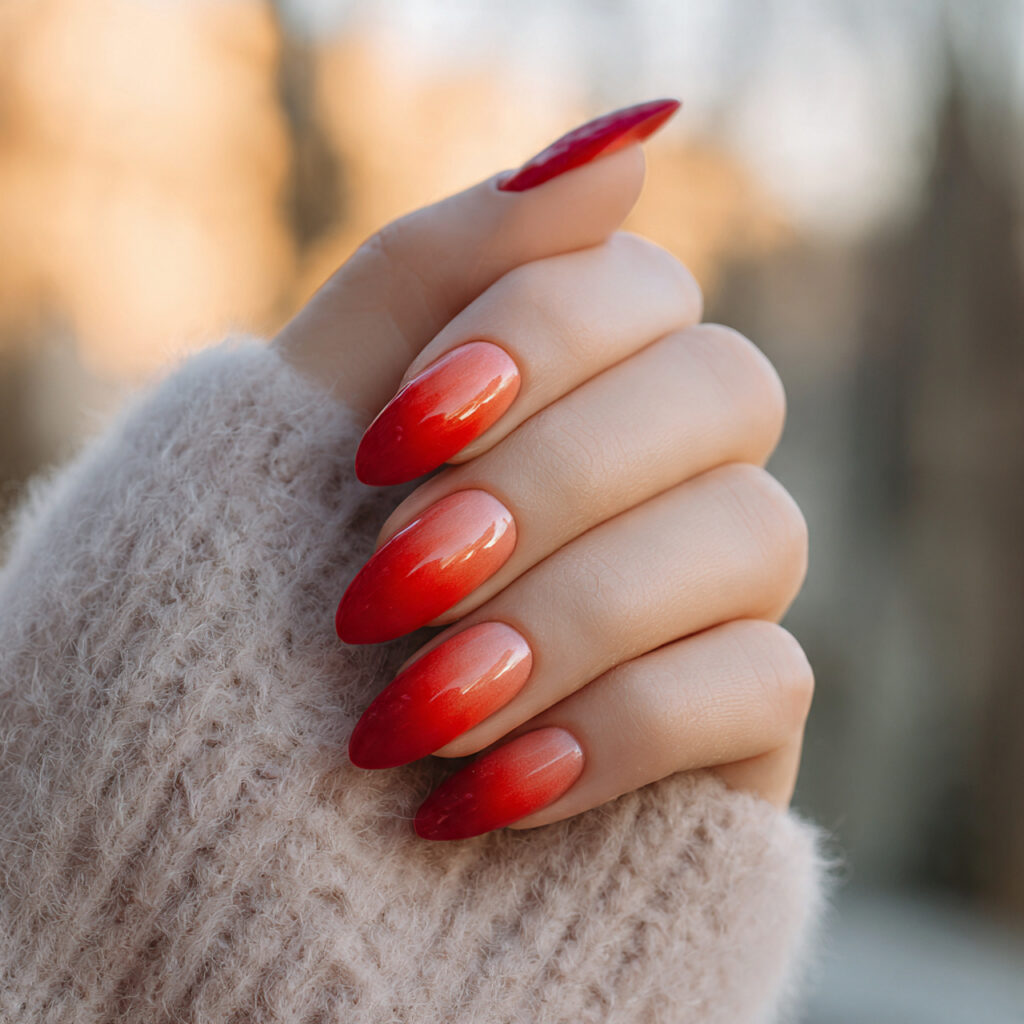 Red Nails Inspo 2026: Bold, Glossy & Totally Addictive Looks 10 close up of one hand with red ombre fade nails ele