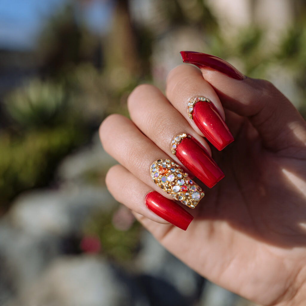 Red Nails With Gold: The Luxe, Glowing Combo You’ll Be Obsessed With 10 close up of one hand with red rhinestone and gold