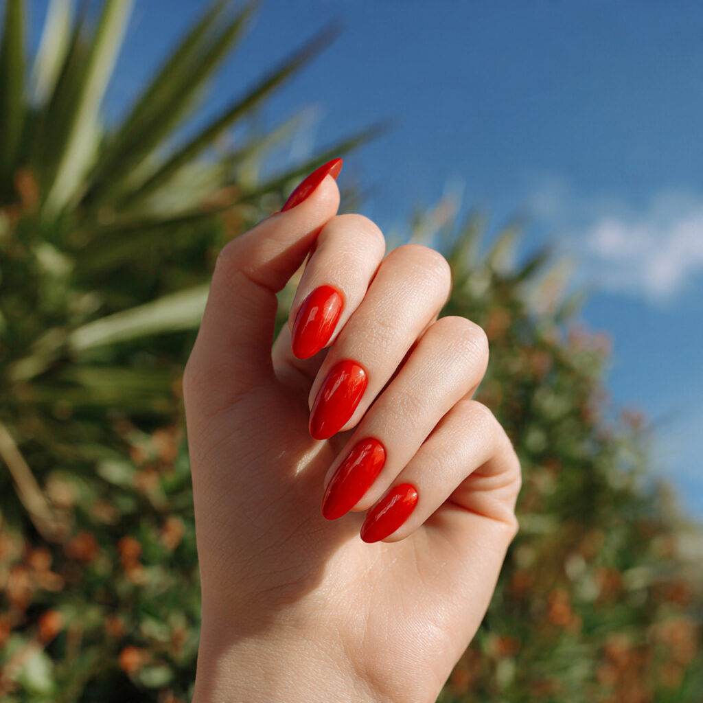 one hand with attractive red chrome nails glossy f