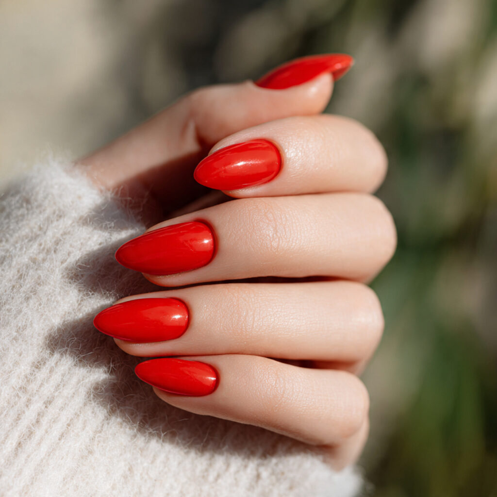 Red Quince Nails: Regal, Romantic & Made for Your Main Character Moment 1 one hand with red almond shaped nails with a soft 1 1